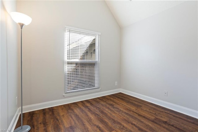 empty room featuring lofted ceiling and dark hardwood / wood-style floors