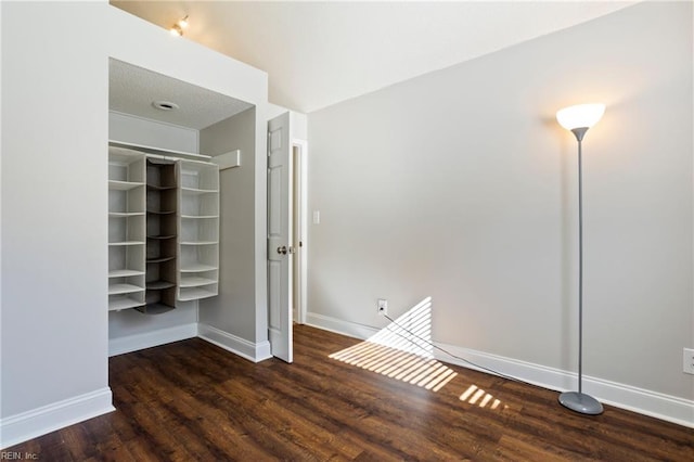 unfurnished bedroom featuring dark hardwood / wood-style floors