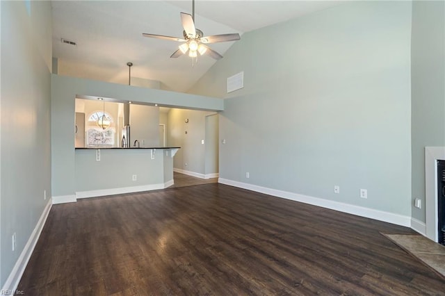 unfurnished living room with ceiling fan, dark hardwood / wood-style floors, and high vaulted ceiling