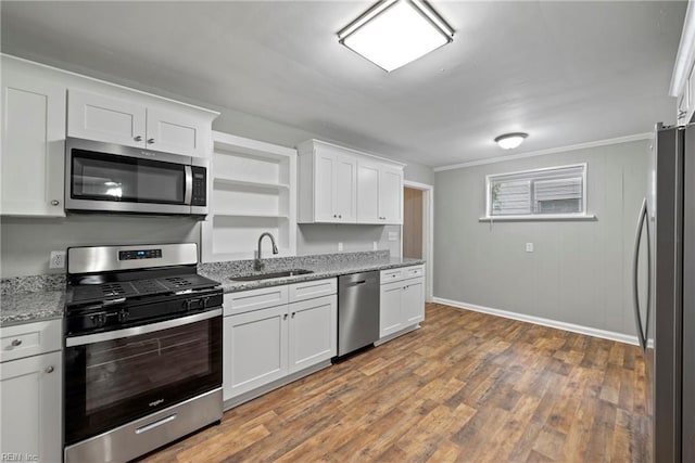 kitchen with sink, hardwood / wood-style floors, stainless steel appliances, light stone countertops, and white cabinets