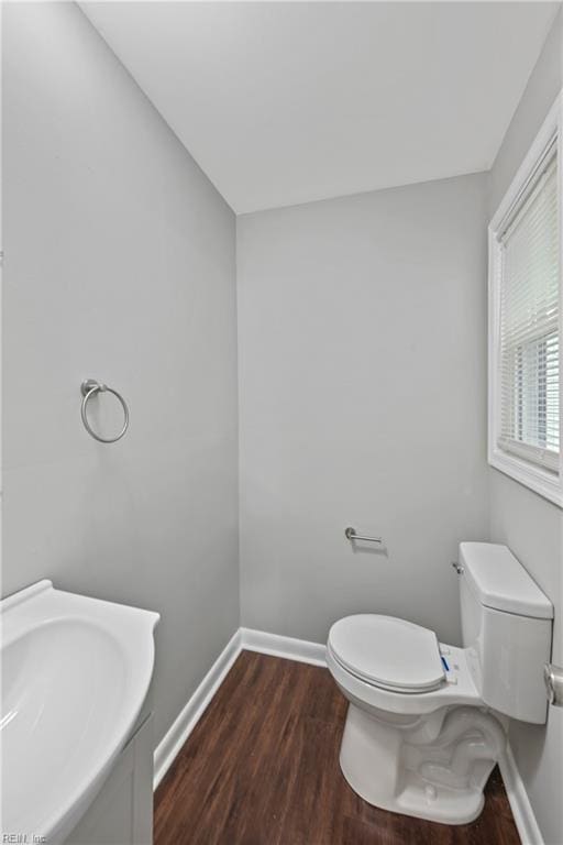 bathroom featuring sink, hardwood / wood-style flooring, and toilet