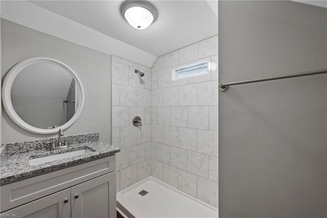 bathroom featuring vanity and a tile shower