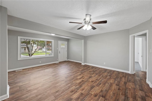 unfurnished room featuring ceiling fan, dark hardwood / wood-style floors, and a textured ceiling