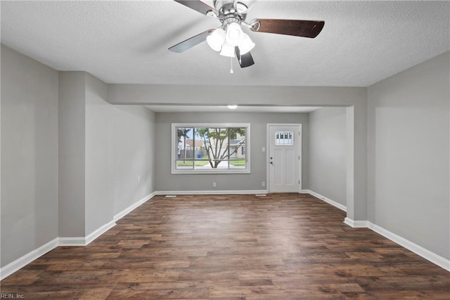 foyer entrance featuring dark hardwood / wood-style flooring and a textured ceiling