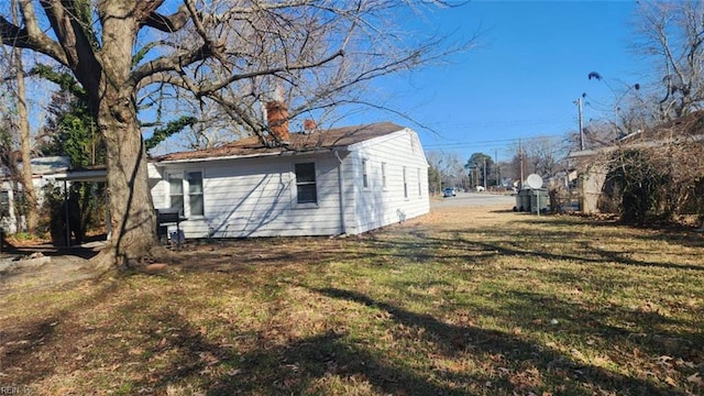 back of house with a lawn