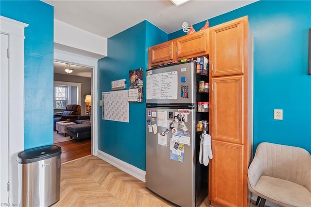 kitchen featuring stainless steel refrigerator and light parquet flooring