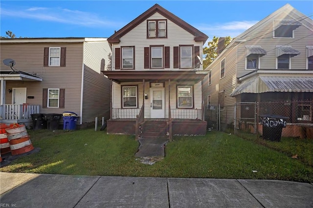 view of front facade with a front yard and a porch