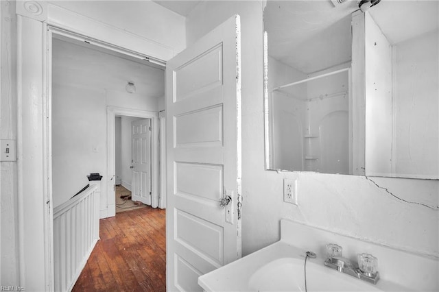 bathroom featuring sink, hardwood / wood-style floors, and a shower