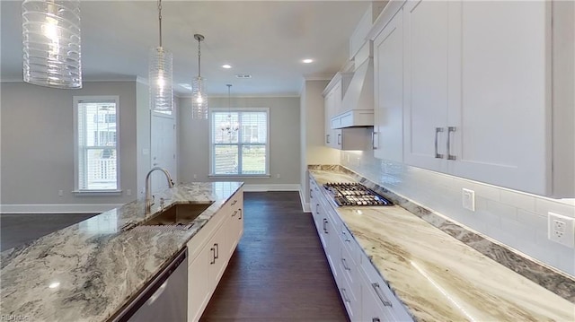 kitchen featuring sink, white cabinetry, crown molding, light stone counters, and stainless steel appliances