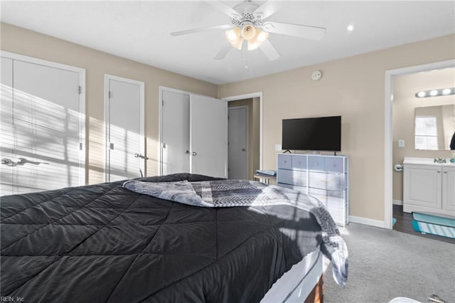 bedroom with carpet floors, ceiling fan, and ensuite bathroom