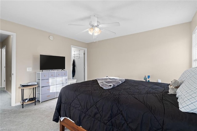 carpeted bedroom with a spacious closet, a closet, and ceiling fan