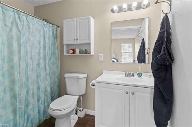 bathroom with vanity, hardwood / wood-style floors, a textured ceiling, and toilet