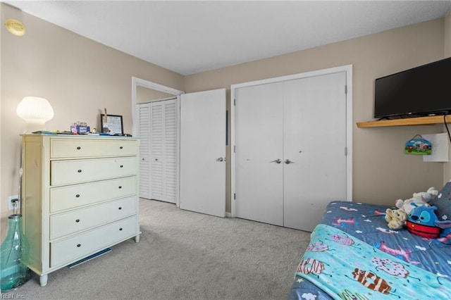 carpeted bedroom with multiple closets