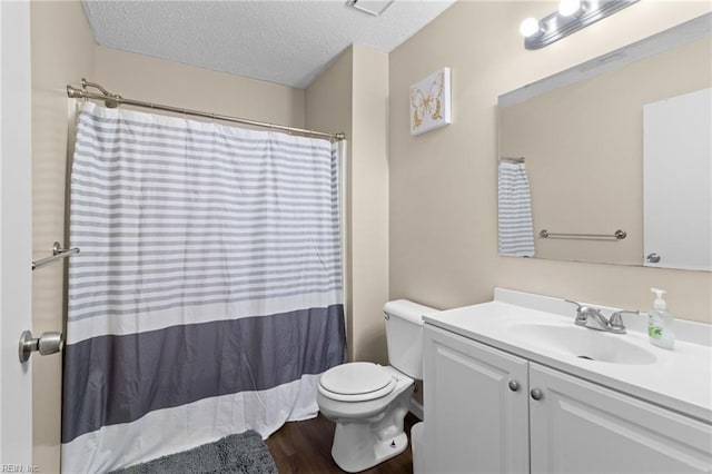 bathroom featuring toilet, a textured ceiling, vanity, curtained shower, and hardwood / wood-style flooring