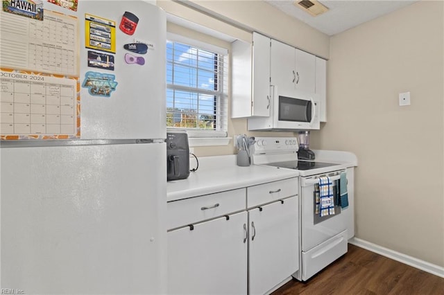 kitchen with dark wood-type flooring, white appliances, and white cabinets