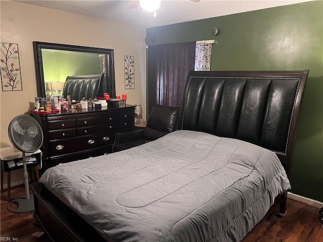 bedroom with hardwood / wood-style flooring, a textured ceiling, and ceiling fan