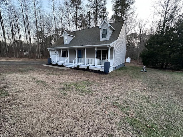 cape cod house with a porch and a front lawn