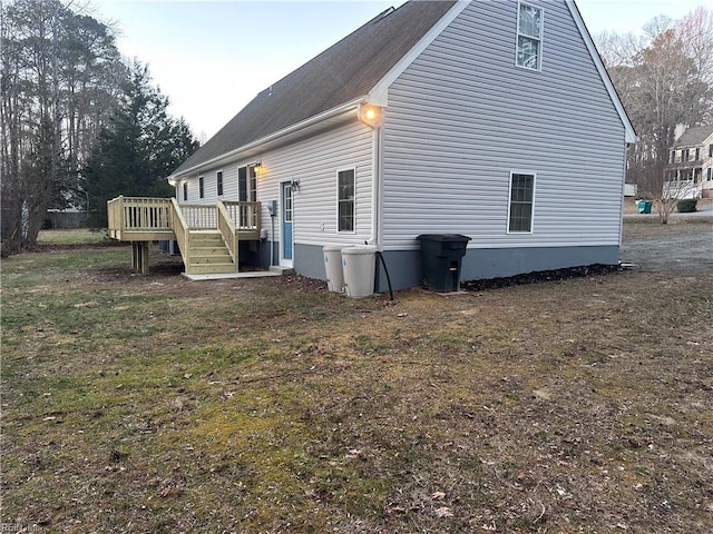 view of home's exterior featuring a yard and a deck