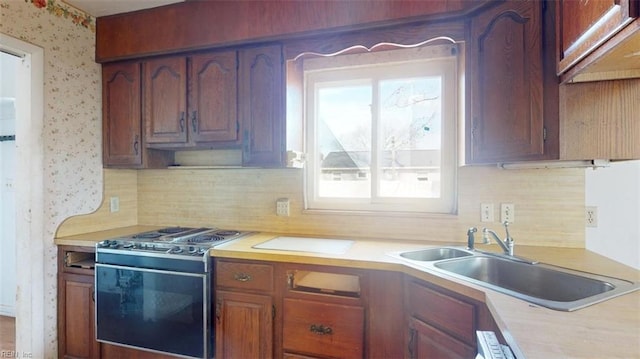 kitchen with range with electric cooktop, sink, and backsplash