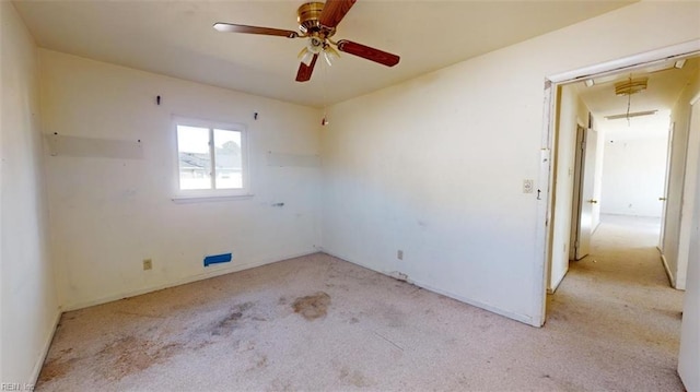 unfurnished room featuring ceiling fan and light colored carpet