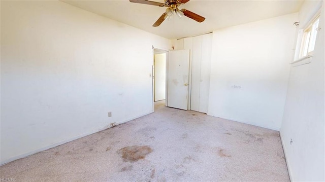 carpeted empty room with ceiling fan