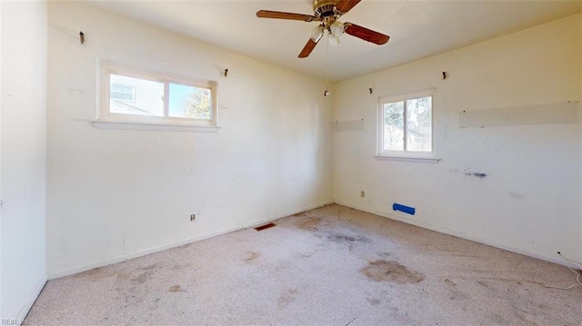 unfurnished room featuring ceiling fan and light carpet