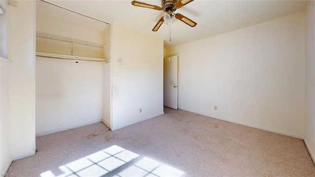 unfurnished bedroom featuring light carpet, a closet, and ceiling fan