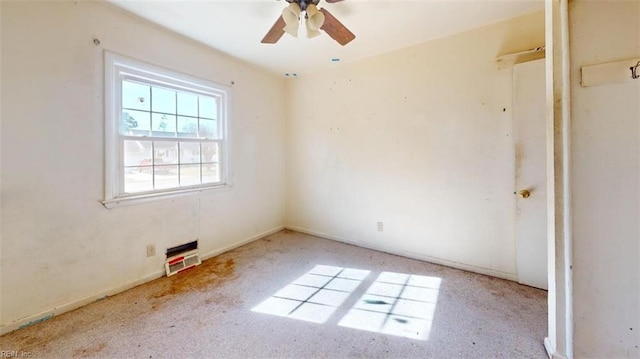 carpeted spare room with ceiling fan