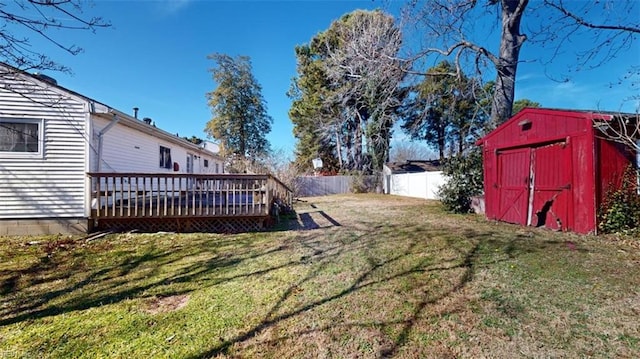 view of yard featuring a storage unit and a deck