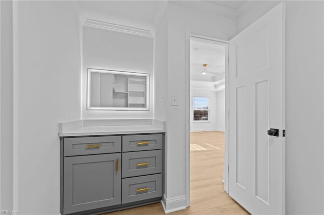 interior space featuring crown molding, vanity, and hardwood / wood-style flooring