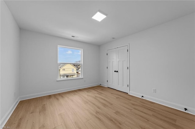 spare room featuring light hardwood / wood-style flooring