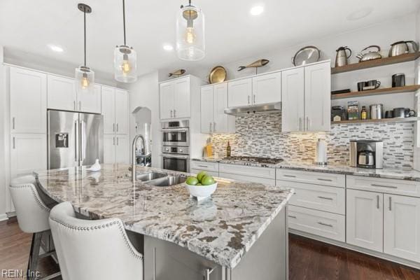 kitchen featuring white cabinetry, backsplash, and stainless steel appliances