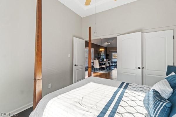 bedroom featuring lofted ceiling, ceiling fan, and a closet