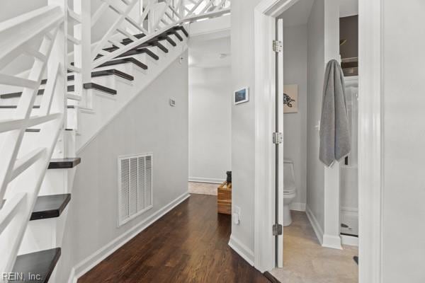 stairway with hardwood / wood-style floors