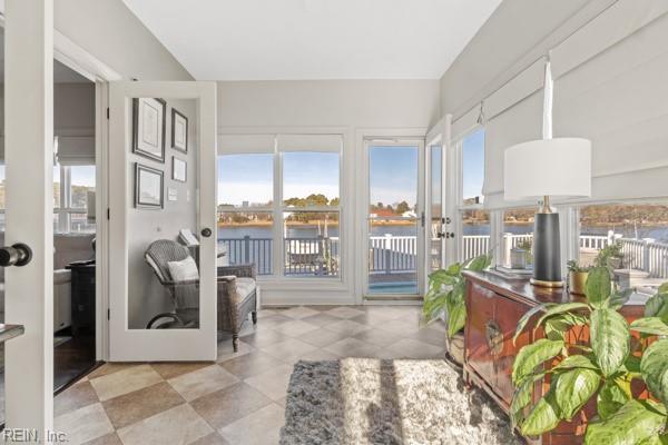 sunroom / solarium with a water view