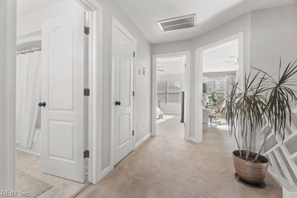 corridor with light colored carpet