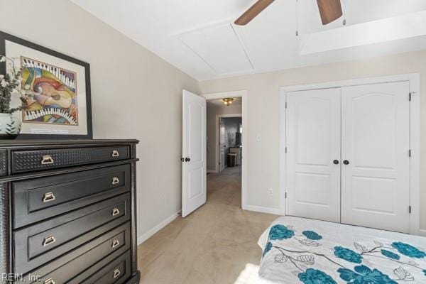 bedroom with light carpet, ceiling fan, and a closet