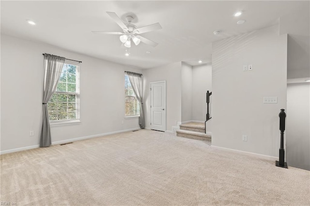 unfurnished room with light carpet and ceiling fan