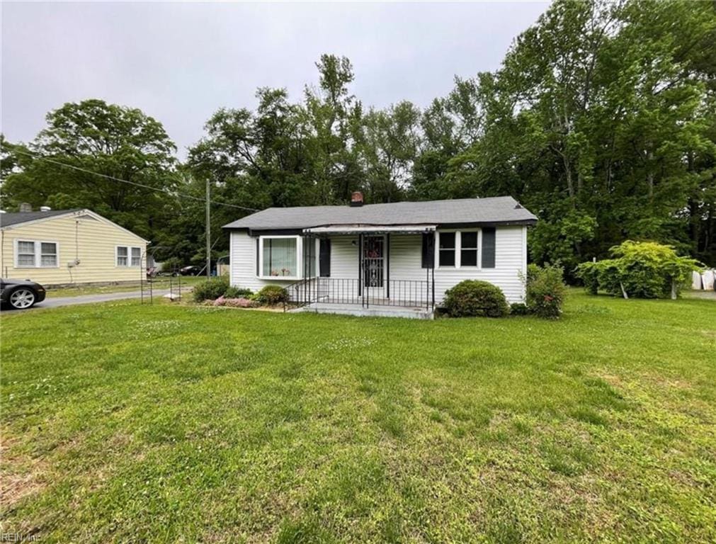 ranch-style house with a front lawn and a porch