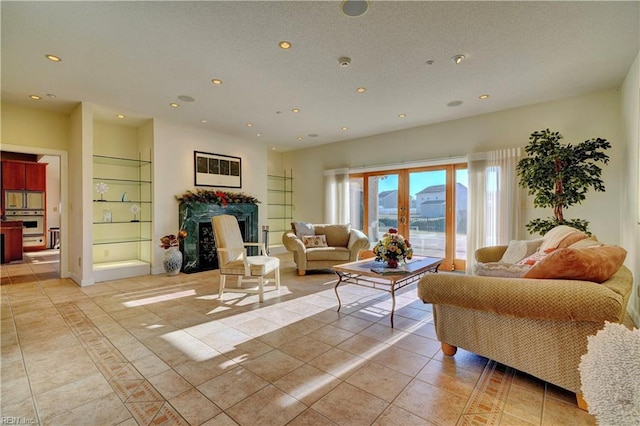 living room featuring built in features, french doors, and light tile patterned flooring