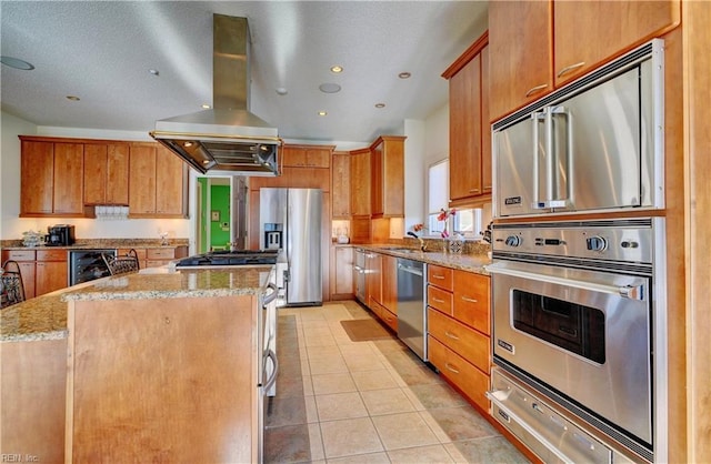 kitchen with light tile patterned floors, island exhaust hood, appliances with stainless steel finishes, and a kitchen island