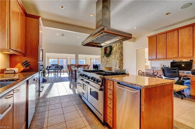 kitchen with stainless steel appliances, island exhaust hood, light stone counters, a textured ceiling, and light tile patterned flooring