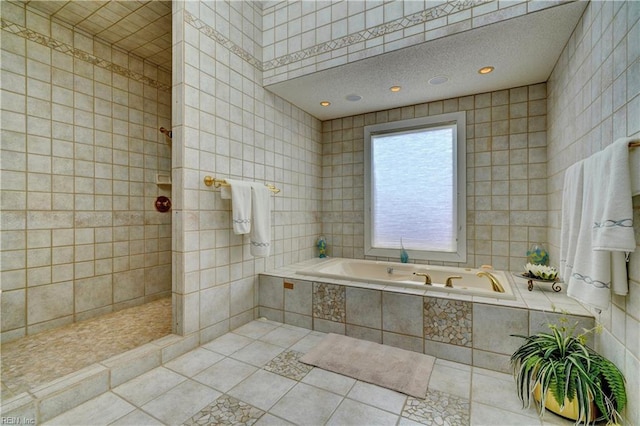 bathroom with tile walls, tile patterned flooring, and separate shower and tub