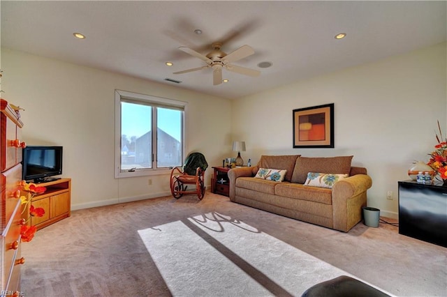 carpeted living room featuring ceiling fan