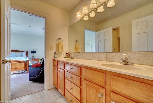 bathroom featuring tile patterned floors, vanity, and backsplash