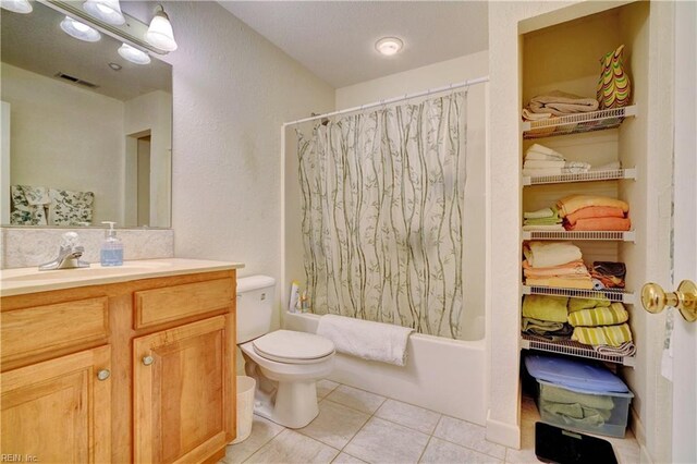 full bathroom with tasteful backsplash, vanity, toilet, shower / bath combo, and tile patterned floors