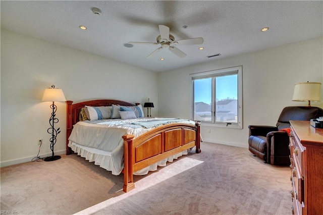 bedroom with ceiling fan and light carpet