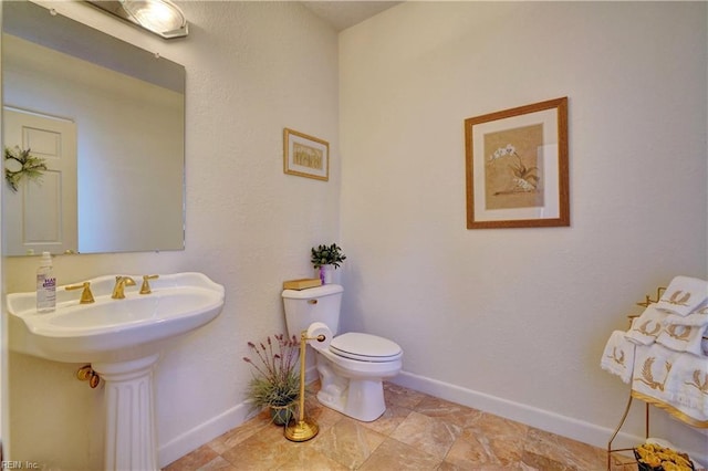 bathroom featuring sink, tile patterned floors, and toilet