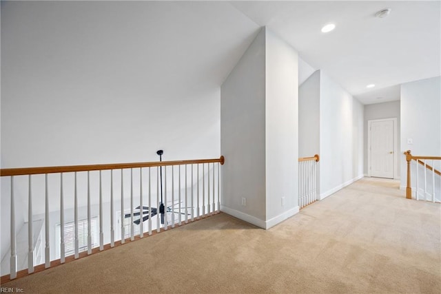 hall with light colored carpet