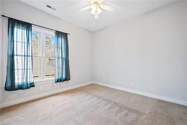 empty room with ceiling fan, a healthy amount of sunlight, and carpet flooring